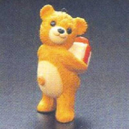 Aunt Krismas 'Cinnamon Bear with Gift' ornament by Hallmark. Year: 1986 - Porcelain Bear series #4. 'Mint In Box' condition.