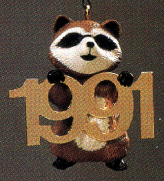 Aunt Krismas 'Raccoon with Brass 1991' ornament by Ed Seale. Year: 1991 - Fabulous Decade series #2. 'Mint In Box' condition.