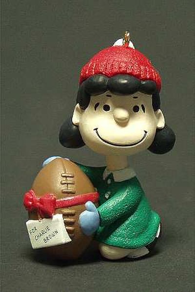 Aunt Krismas 'Lucy/Football with Red Ribbon' ornament by Ron Bishop. Year: 1994 - The Peanuts Gang series #2. 'Mint In Box' condition.